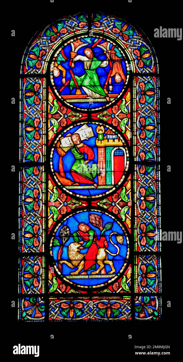 Stained Glass window, Story of Samson, killing a lion, striding away with gates of Gaza, pushing down the pillars to destroy the Philistines, by Alfre Stock Photo