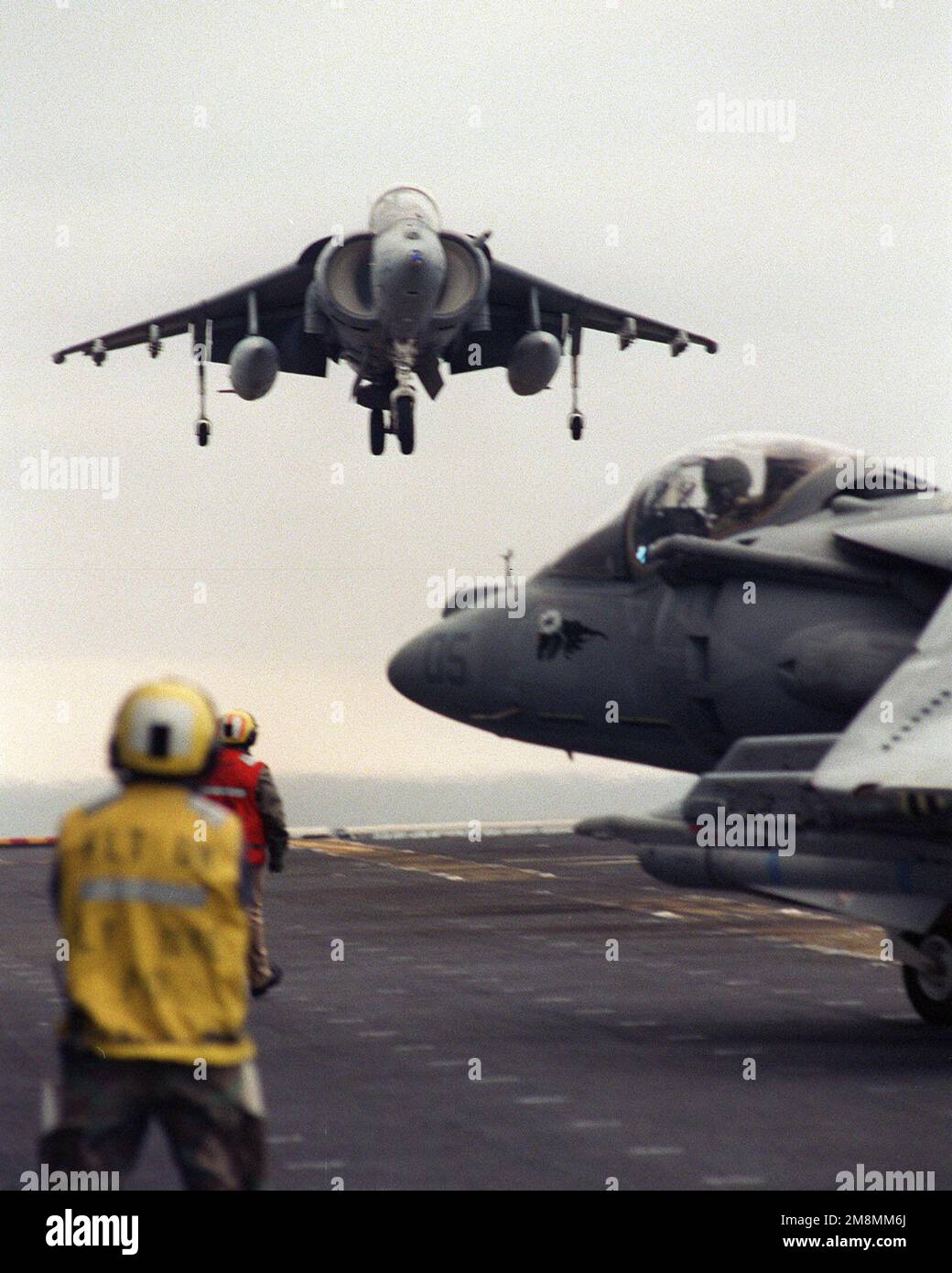 A Marine Corps AV-8B Harrier lands on the flight deck of the USS ...