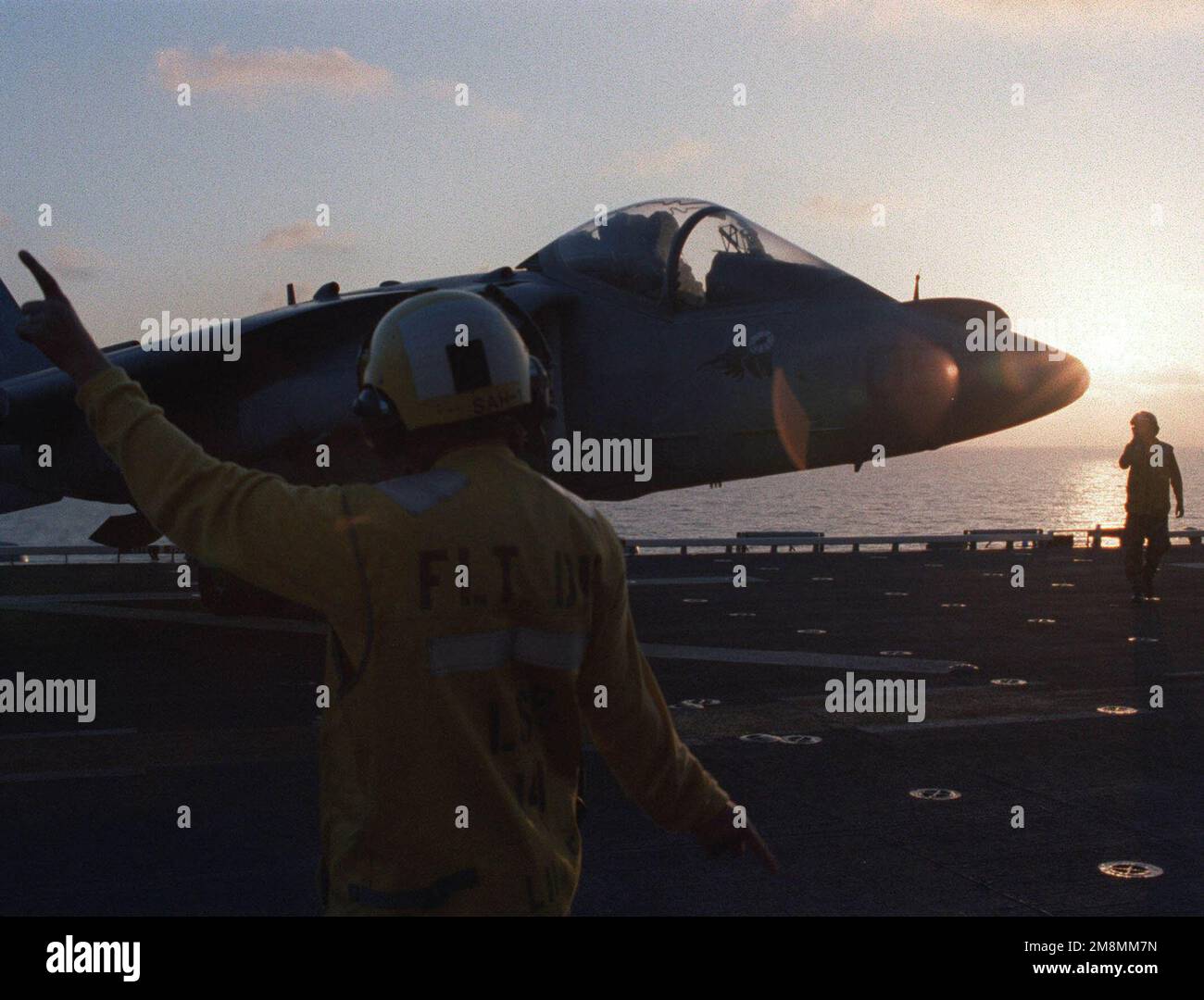 Aviation Boatswain's Mate First Class (ABH1) Olson directs a Marine