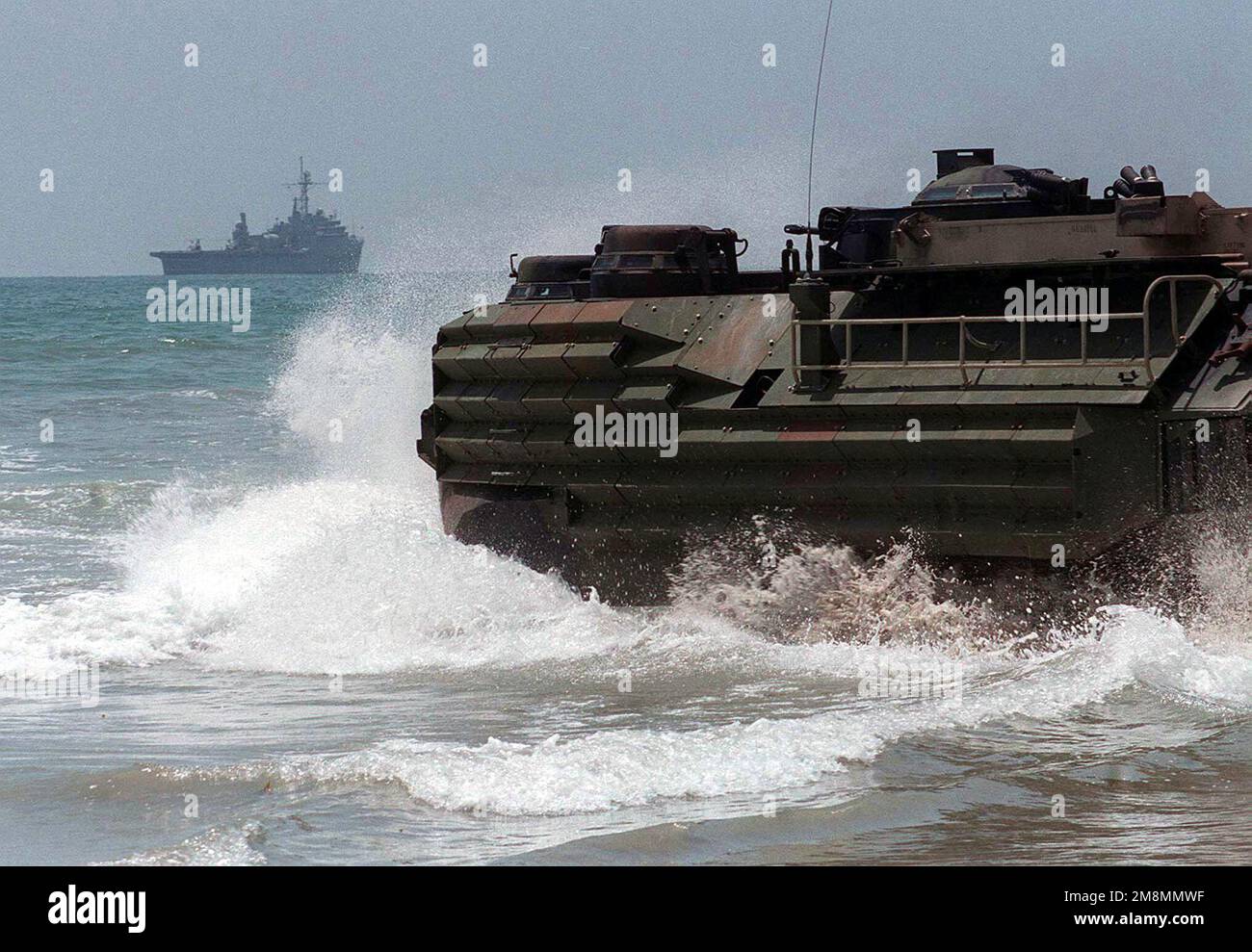An Amphibious Assault Vehicle (AAV-7A1) from 3d Amphibious Assault Battalion returns to the USS Anchorage (LSD-36) from White Beach during Exercise KERNEL BLITZ '97. KERNEL BLITZ is a bi-annual Commander-in-CHIEF Pacific (CINCPAC) fleet training exercise (FLEETEX) focused on operational/tactical training of Commander, Third Fleet (C3F)/ I Marine Expeditionary Forces (MEF) and Commander, Amphibious Group 3 (CPG-3)/ 1ST Marine Division (MARDIV). KERNEL BLITZ is designed to enhance the training of Sailors and Marines in the complexities of brigade-size amphibious assault operations. (Duplicate im Stock Photo