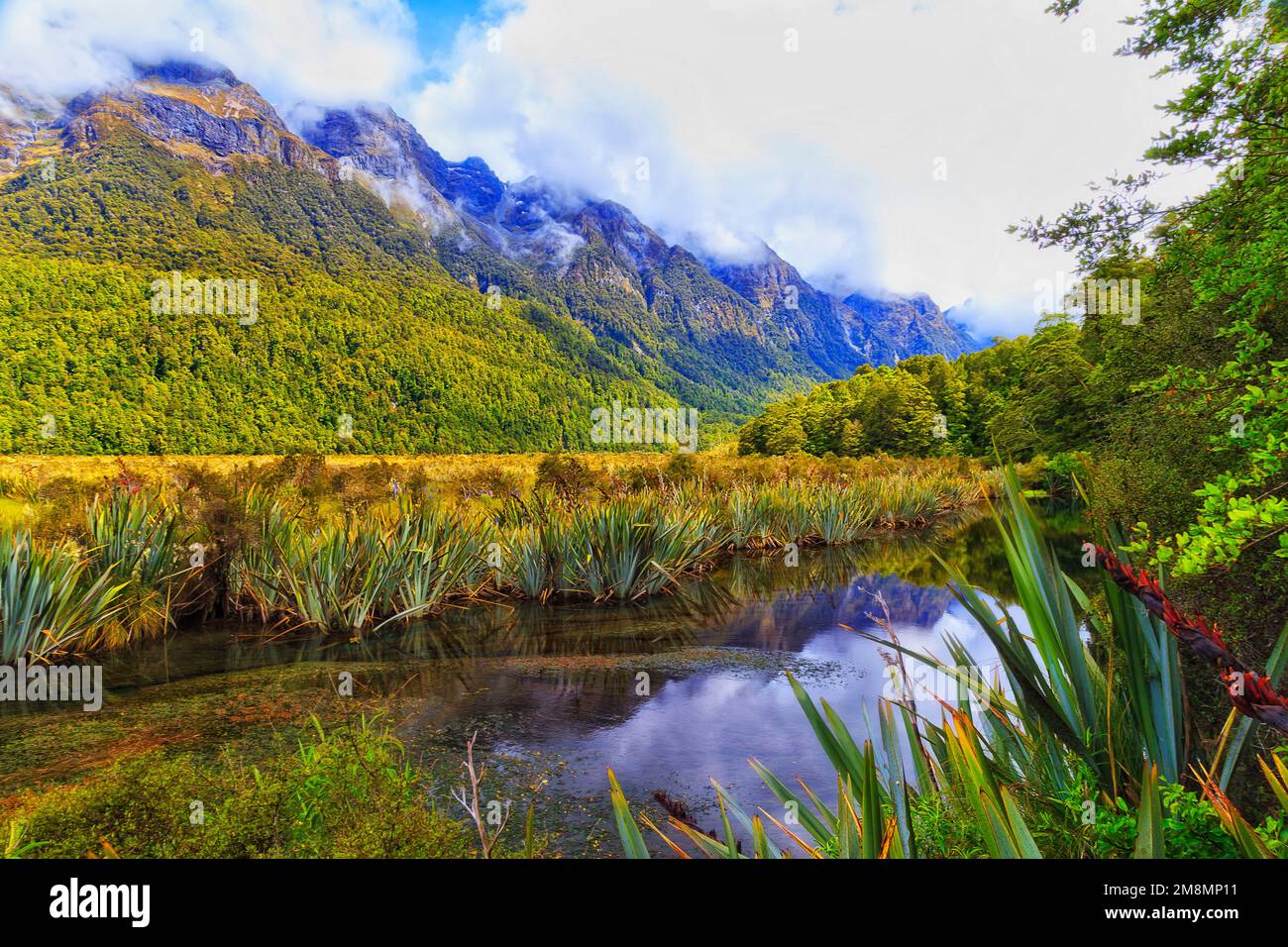 Scenic mountains around Mirror lake on Eglinton river in New Zealand Milford Sound national park at Fiordland. Stock Photo