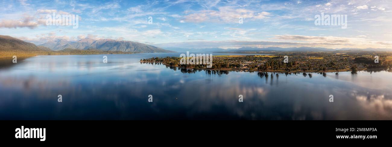 Scenic wide aerial panorama of Te Anau lake and Te Anau town in New Zealand - a gateway to Milford Sound fiordlands. Stock Photo
