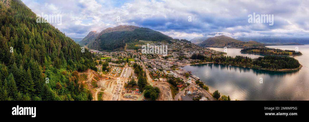 Aerial panorama of Queenstown in New Zeland from Ben lomond mount slope to downtown and lake Wakatipu. Stock Photo