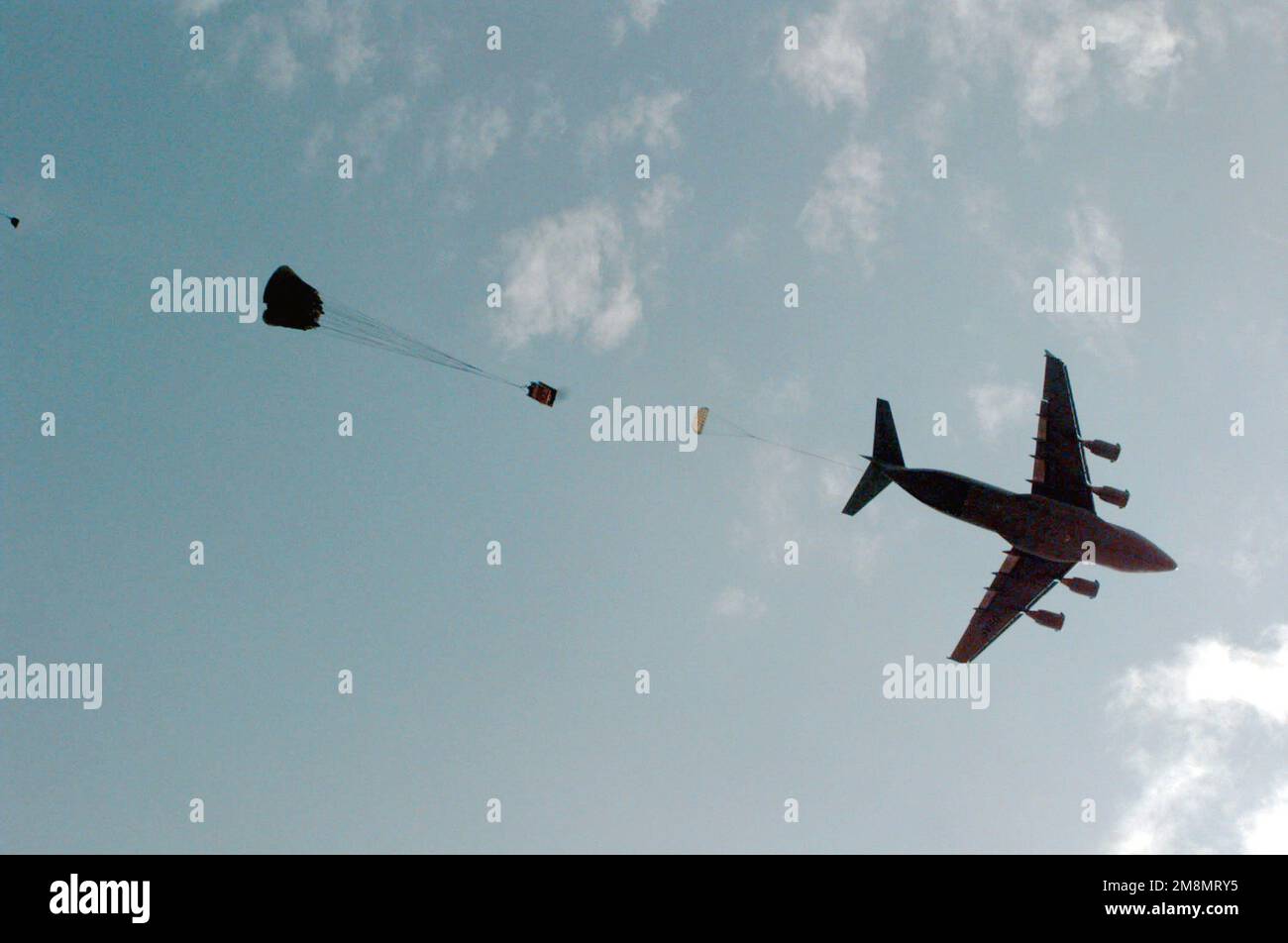 Trailing out of the back of a U.S. Air Force C-17 aircraft, heavy ...