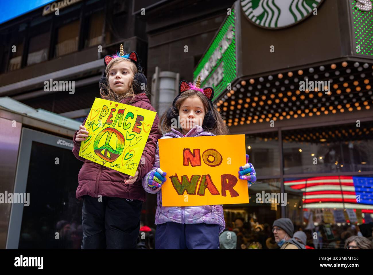 New York, United States. 14th Jan, 2023. Two young anti-war demonstrators hold homemade signs to protest against the war in Ukraine in Times Square. Attendees called for NATO, a security alliance of 30 countries, to negotiate a peaceful resolution after Russian President Vladimir Putin launched a full-scale invasion of Ukraine nearly 11 months ago. (Photo by Michael Nigro/Pacific Press) Credit: Pacific Press Media Production Corp./Alamy Live News Stock Photo