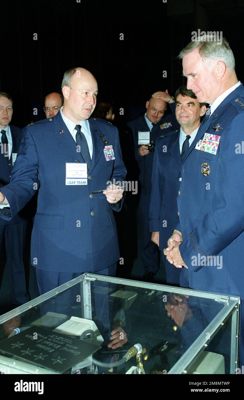 LTC Edward Wexler, Georgia Air National Guard, gives GEN Michael E. Ryan (center), Air Force CHIEF of STAFF, a tour of the Garden City booth at the Air Force Quality Symposium held in the Montgomery Civic Center. Base: Montgomery State: Alabama (AL) Country: United States Of America (USA) Stock Photo