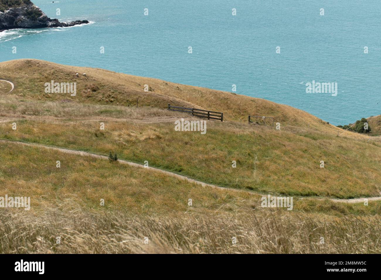 A path with a sea view. A road for hiking with a stunning landscape. Landscape. Stock Photo