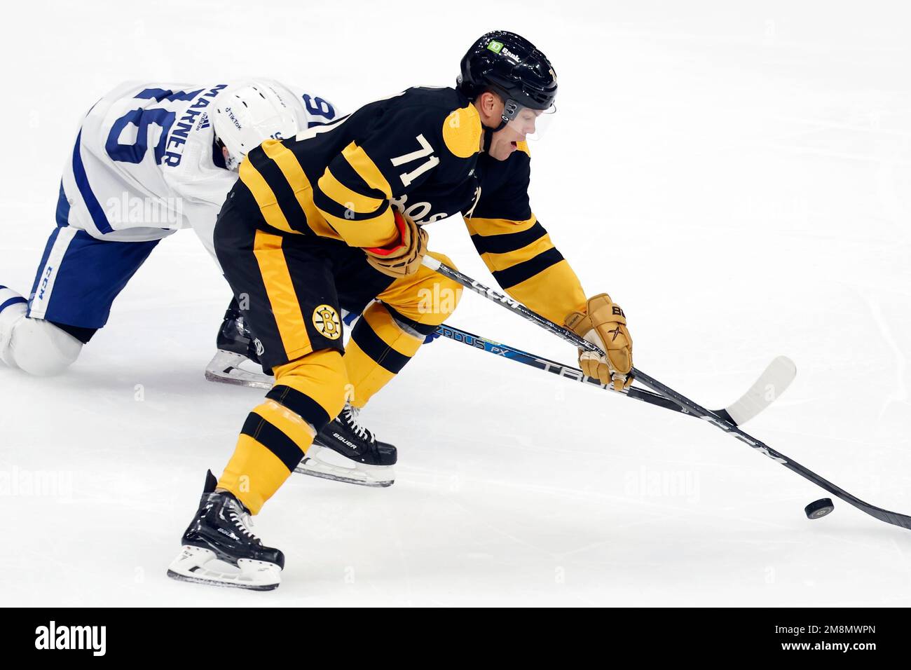Toronto Maple Leafs' Mitchell Marner (16) battles Boston Bruins' Taylor