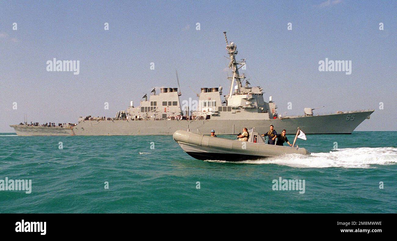 A rigid hull inflatable boat rhib passes the us navy guided missile