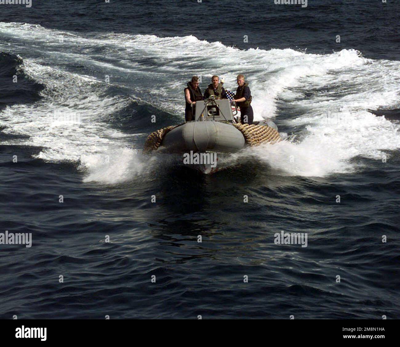 Electrician's Mate 2nd Class Matt Oravets, Boatswain's Mate 3rd Class Bill Wendsel, and Engineman 3rd Class Jared Clarkson from USS SAMUEL B. ROBERTS (FFG-58) prepare to use a Rigid Hull Inflatable Boat to help rig up a towing line to a disabled Iranian fishing boat. ROBERTS (not shown) was patrolling the Arabian Sea in support of the Southwest Asia (SWA) build-up when she received orders to assist this ship in distress. Country: Unknown Stock Photo