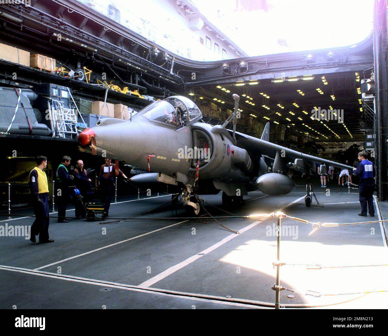 A British Crewman moves a Royal Air Force GR7 Harrier onto the flight