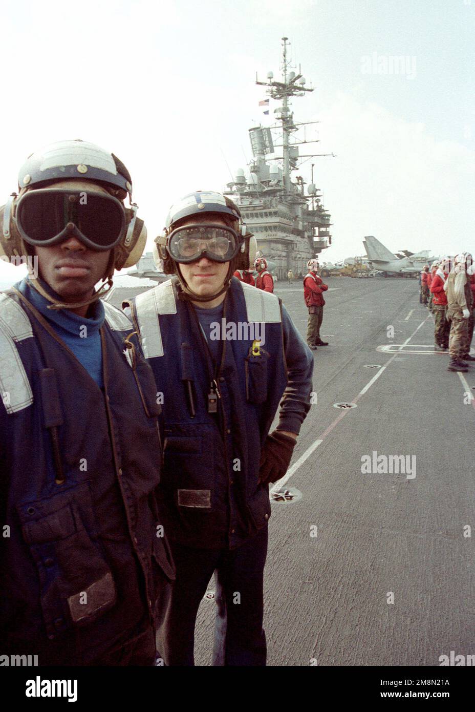 US Navy AIRMAN John E. Jones and AIRMAN Seth Stachlowski await the next launch cycle aboard the Forrestal Class Aircraft Carrier, USS INDEPENDENCE (CV 62). The INDEPENDENCE is deployed to the Persian Gulf in support of Operation Southern Watch. Subject Operation/Series: SOUTHERN WATCH Base: USS Independence (CV 62) Stock Photo