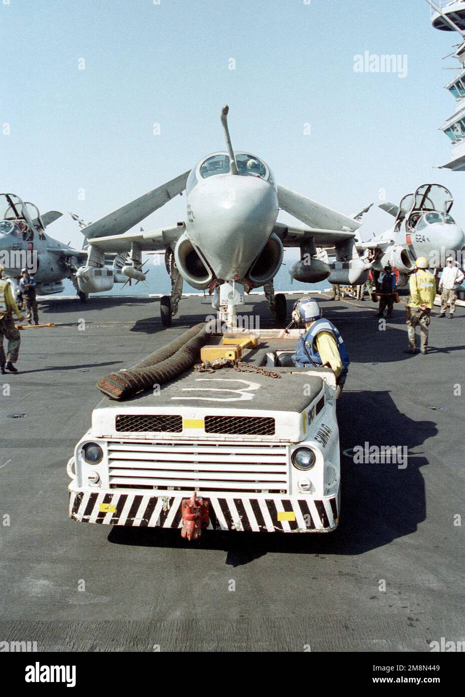 US Navy Aviation Boatswain's Mate 3rd Class (AB3) Justin Morrow backs an EA-6B Prowler into a slot just forward of the super structure on the flight deck of the conventional aircraft carrier USS INDEPENDENCE (CV 62). The INDEPENDENCE is nearing completion of its deployment in the Persian Gulf , in support of Operation SOUTHERN WATCH, 11 May 1998. Subject Operation/Series: SOUTHERN WATCH Base: USS Independence (CV 62) Stock Photo