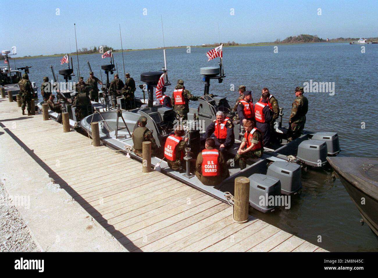 Latin-American Dignitaries board Coast Guard In-Shore Boat Units (IBU)'s in Mile Hammock Bay, New River, in preparation to travel to the riverine insertion location to witness the Riverine Insertion Operation Exercise (RIOEX) '98 at Camp Lejeune, North Carolina, for possible application to thier own armed forces. Subject Operation/Series: RIOEX '98 Base: Marine Corps Base, Camp Lejeune State: North Carolina (NC) Country: United States Of America (USA) Stock Photo