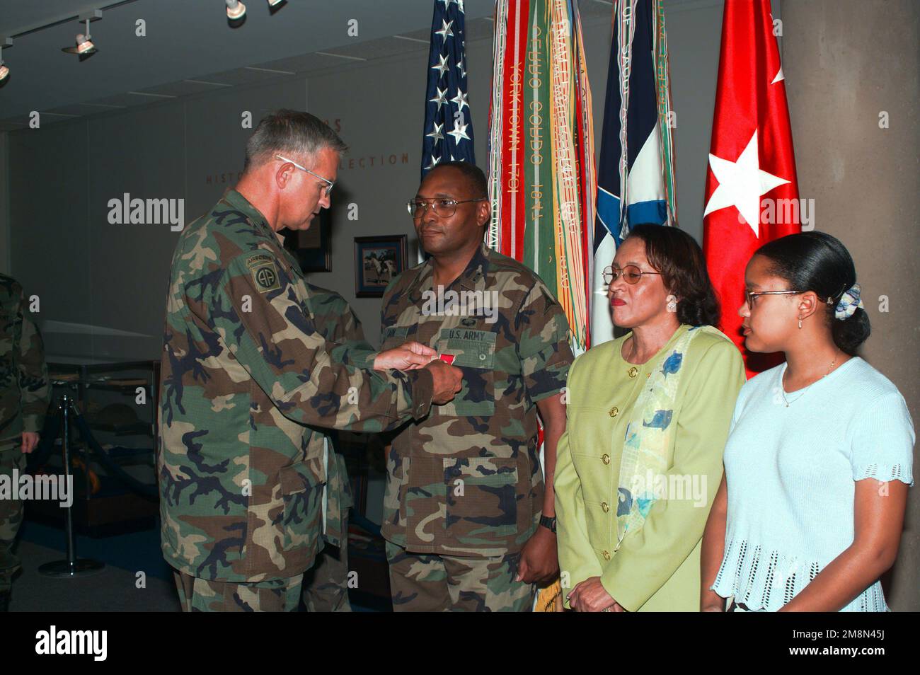LTG Thomas A. Schwartz (left), Commanding General of III Corps and Fort Hood present the Legion of Merit medal to COL Eddie Cain for his exceptionally meritorious service while assigned as chemical officer, III Corps and Fort Hood. Looking on are the colonel's wife Fredia (second from right) and his daughter Trina (right). Base: Fort Hood State: Texas (TX) Country: United States Of America (USA) Stock Photo