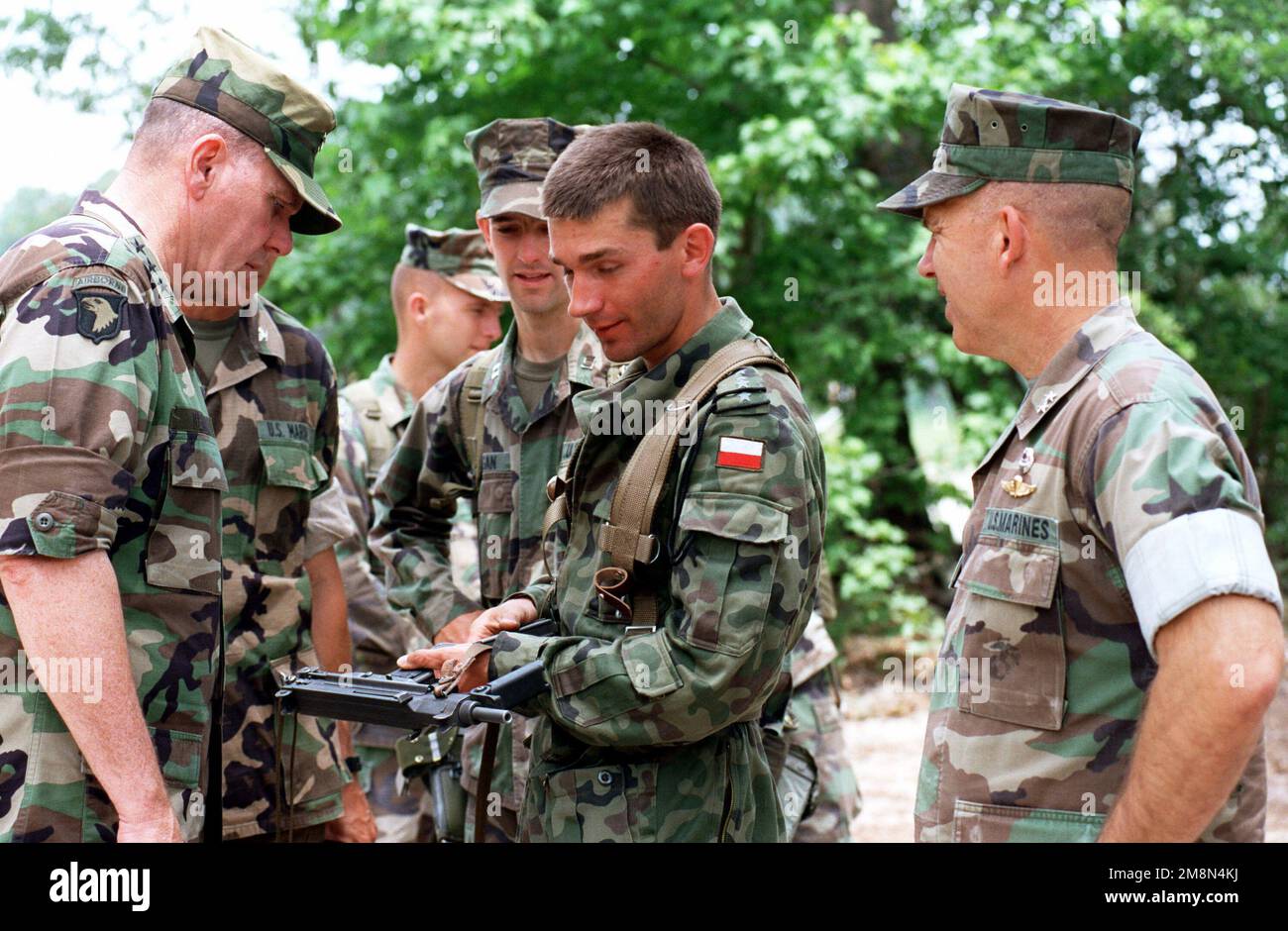 US Army Lieutenant General John Keane (left) and Marine Major General Wayne E. Rollings (right) discuss the virtues and idiosyncrasies of a Polish Glauberyt PM-84 9 mm Machine Pistol, with Company 1, Polish and Lithuanian soldiers during Situational Training Exercise 5 (STX5). Base: Marine Corps Base, Camp Lejeune State: North Carolina (NC) Country: United States Of America (USA) Stock Photo