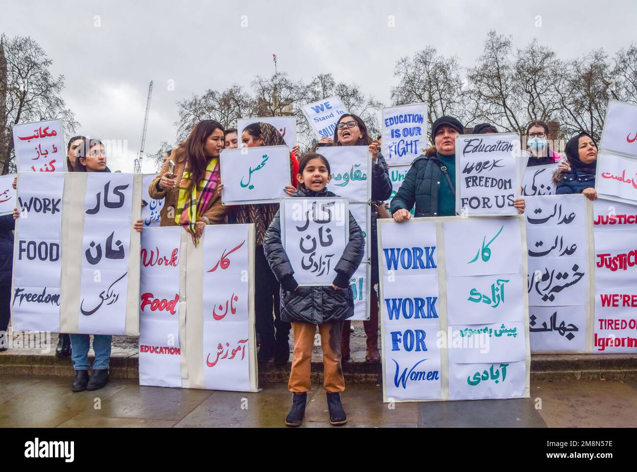 London, UK. 14th Jan, 2023. Protesters hold placards in support of women's rights to education, food, work and freedom during the demonstration in Parliament Square. A group of protesters gathered in support of women in Afghanistan and in protest against the Taliban government. Credit: SOPA Images Limited/Alamy Live News Stock Photo