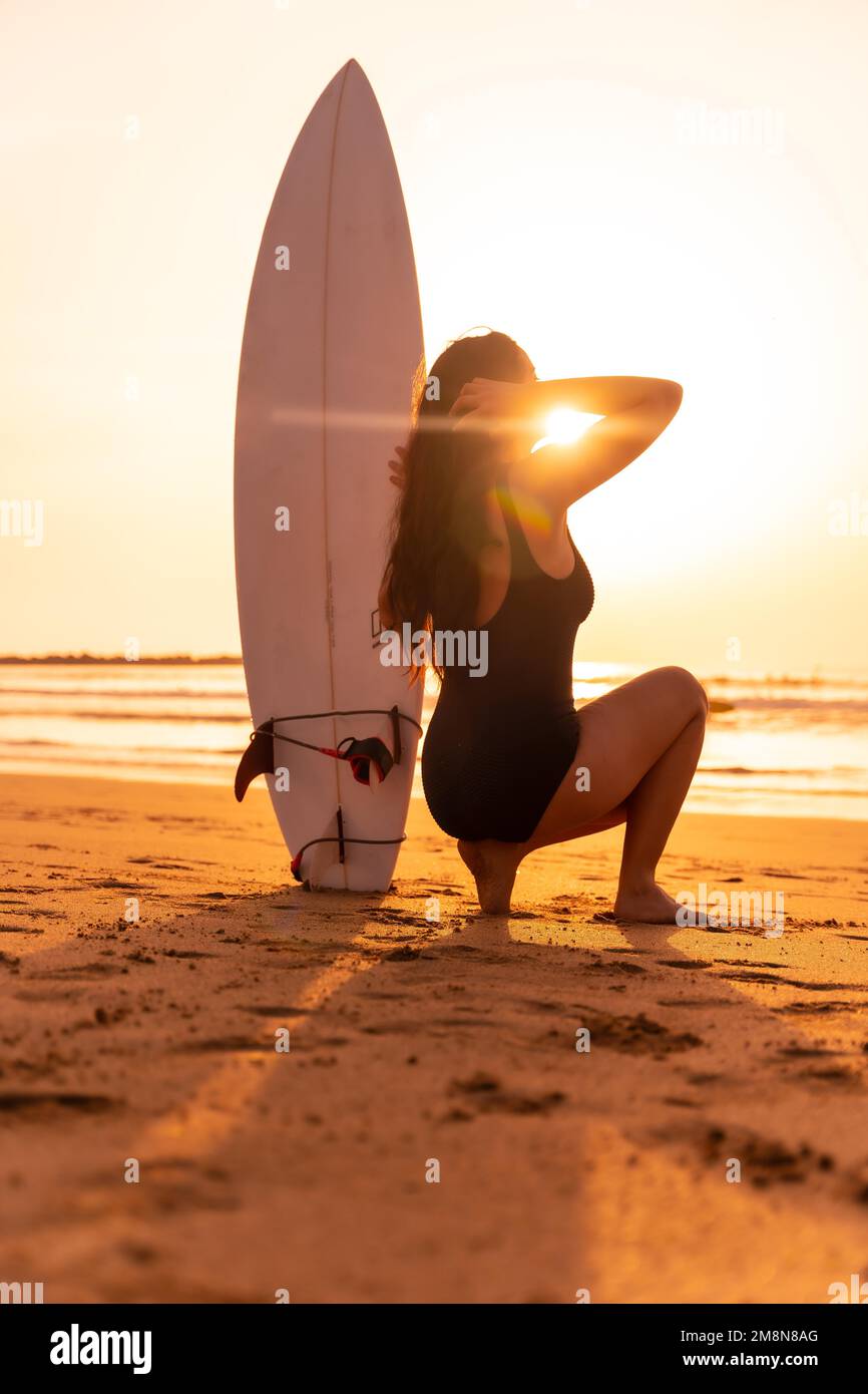 Female surfer beach sunset hi-res stock photography and images - Alamy