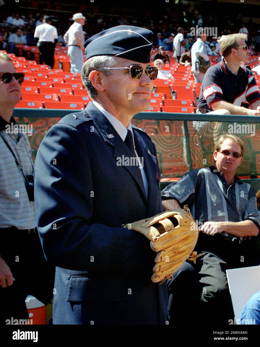 Medium shot, right front view, Brigadier General Steven A. Roser, USAF, commander of the 60th Air Mobility Wing at Travis AFB, Ca., prepares to throw out the first pitch at Travis Day at Oakland Coliseum, Oakland, California during the Oakland A's game. General Roser had given the oath to approximately 20 people enlisting in the Air Force out on the ballfield. Base: Travis Air Force Base State: California (CA) Country: United States Of America (USA) Stock Photo