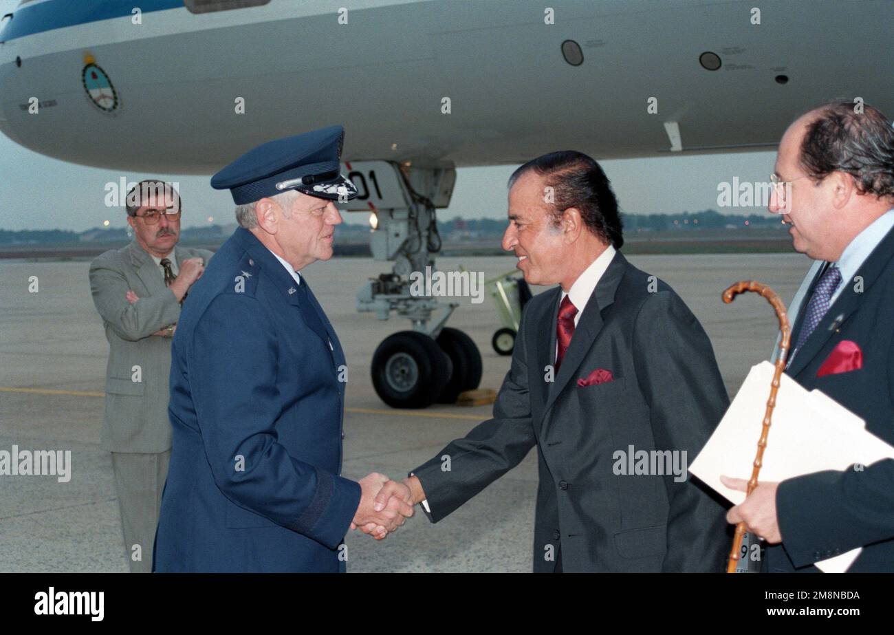 Brigadier General Arthur J. Lichte Commander, 89th Airlift Wing, greets Dr. Carlos D. Menen, President of Argentina, upon his arrival at Andrews Air Force Base, Maryland. Base: Andrews Air Force Base State: Maryland (MD) Country: United States Of America (USA) Stock Photo