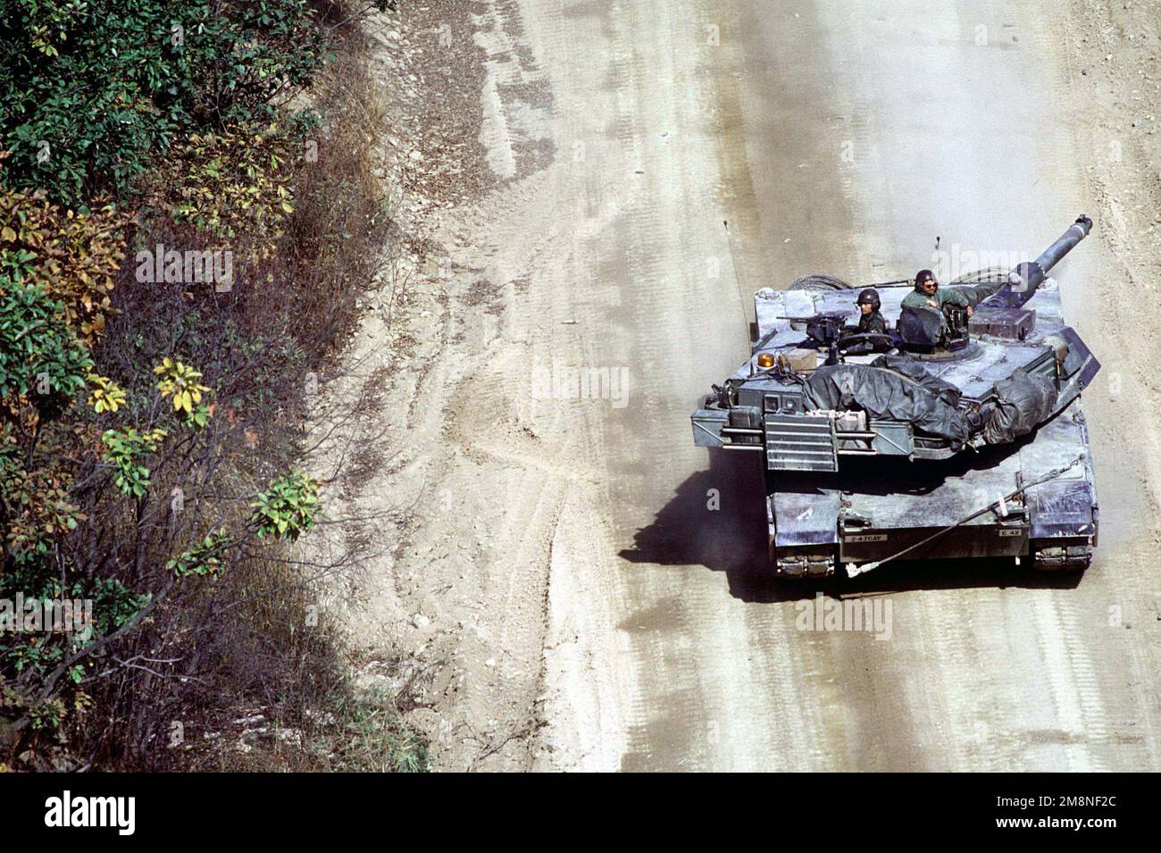 A US Army M1-A1 Abrams tank, from C Troop of the 4th Squadron, 7th Cavalry Regiment drives to the live fire training range at the Korea Training Center, Republic of Korea on Oct. 25, 1998. The center is manned throughout the year and various armored units rotate through training scenarios to meet yearly live gunnery training requirements. Subject Operation/Series: KOREA CD Base: Korea Training Center Country: Republic Of Korea (KOR) Stock Photo