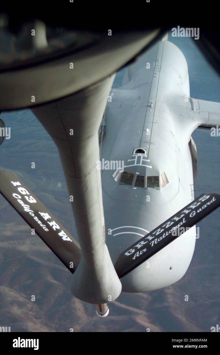 A C-5 Galaxy approaches the boom of a KC-10A Extender with the 163rd Air Refueling Wing from March ARB, California, to begin refueling operation during Exercise Red Flag 99-1 at Nellis AFB, Nevada. Red Flag is a simulated training exercise held by the US and its allies. It is conducted on the vast range north of Nellis AFB. Red Flag is one of a series of advanced training programs administered by the 414th Combat Training Squadron, Air Warfare Center at Nellis AFB. Subject Operation/Series: RED FLAG 99-1 Base: Nellis Air Force Base State: Nevada (NV) Country: United States Of America (USA) Sce Stock Photo