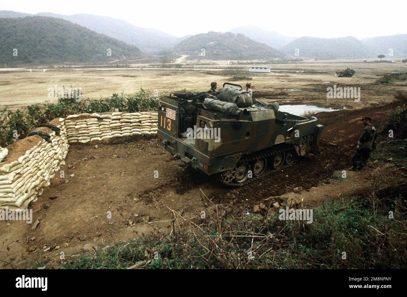 A Republic of Korea Army (ROKA) M-9 Armored Combat Earthmover constructs a tank entrenchment at the Twin Bridges training area on Oct. 31, 1998. Twin Bridges, located 25 minutes west of Tongduch'on, Republic of Korea, is the site for a simulated battle on Nov. 2, 1998 between a ROKA armored brigade and the 3rd Brigade, 2d Infantry Division from Fort Lewis, Washington, during the combined exercise Foal Eagle '98. Subject Operation/Series: FOAL EAGLE '98KOREA CD Base: Tongduchon Country: Republic Of Korea (KOR) Stock Photo