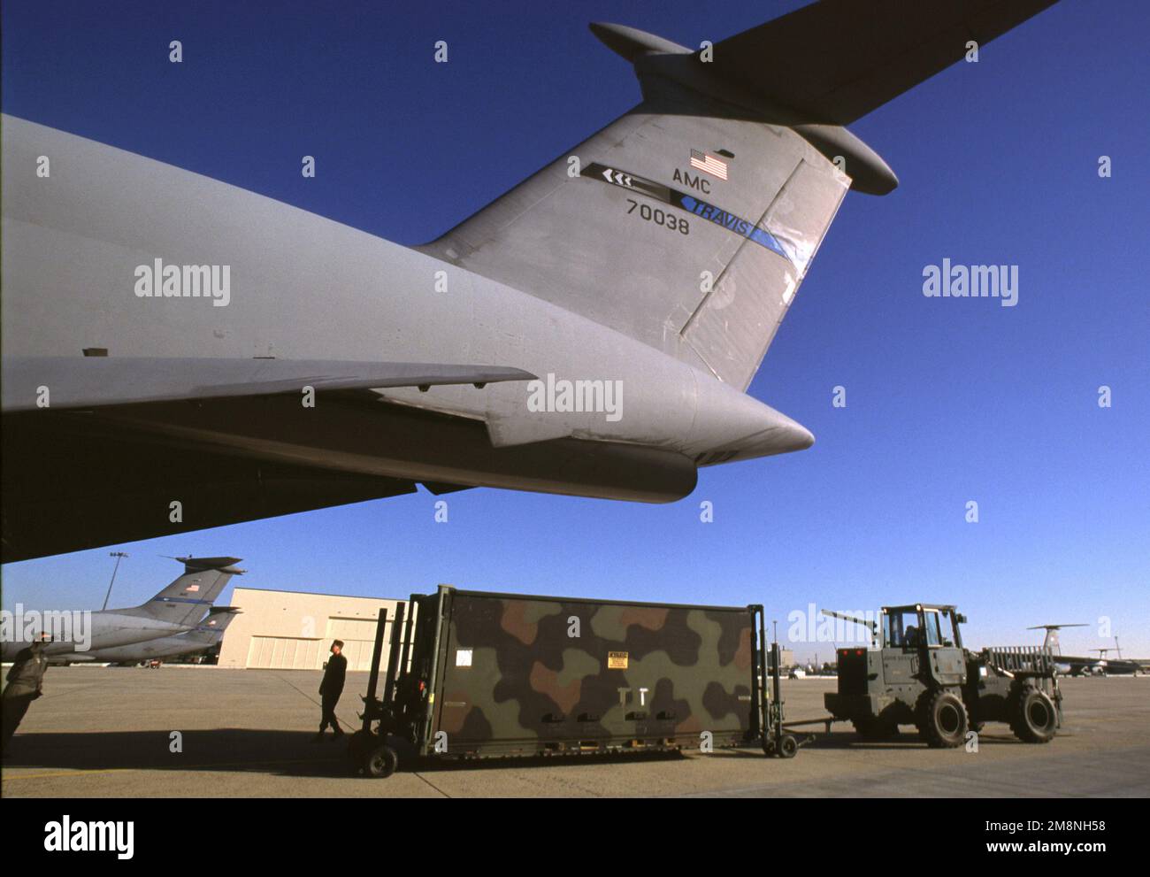 USAF personnel at McGuire AFB, New Jersey use a heavy forklift to