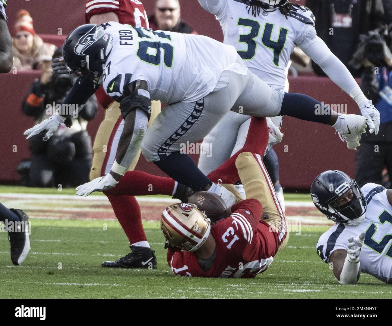 California, USA. 14th Jan, 2023. San Francisco 49ers quarterback Brock Purdy (13) gets stepped on by Seattle Seahawks defensive tackle Poona Ford (97) on a sack in the second quarter of the NFC Wildcard game at Levi's Stadium in Santa Clara, California on Saturday, January 14, 2023. The 49ers defeated the Seahawks 41-23. Photo by Terry Schmitt/UPI Credit: UPI/Alamy Live News Stock Photo