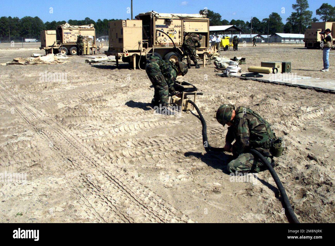 A US Army water purification unit is completing the supply water hookup