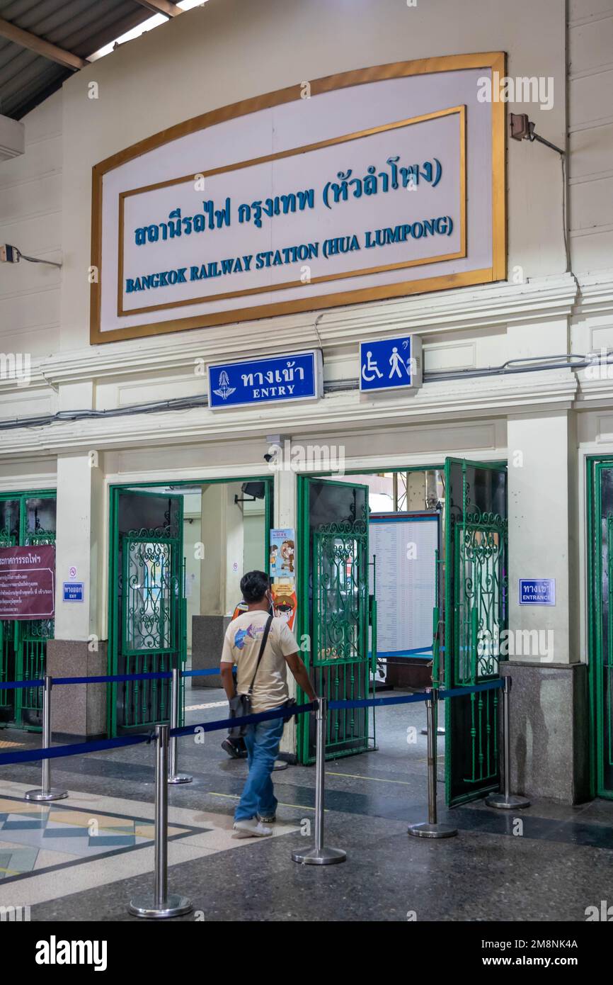 Bangkok, Thailand - October 12th 2020.:A man walks throught the entrace to Hua Lamphong Railway Station. Trains depart from here to all parts of the c Stock Photo