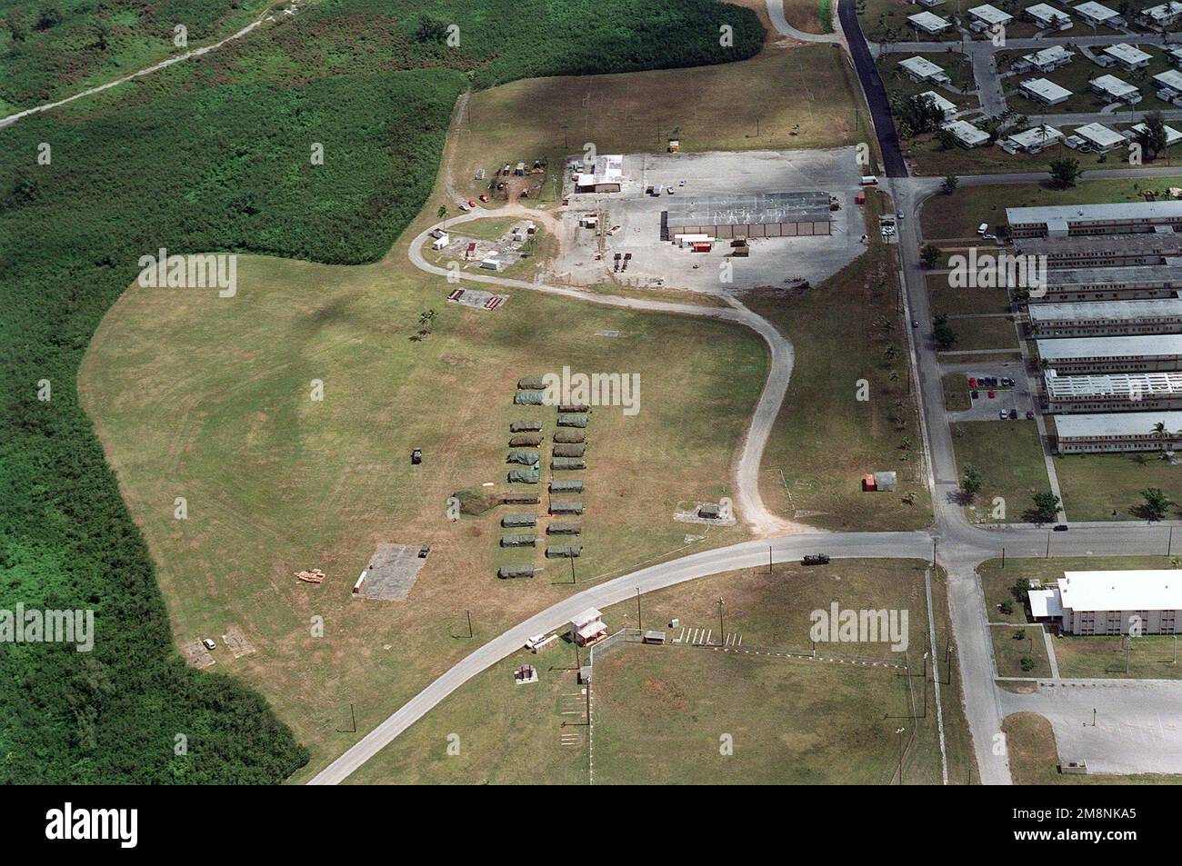 Aerial view the Tent City living facilities for deployed US Military personnel at Agana Naval Air Station, Guam during Exercise TANDEM TRHUST 99. Subject Operation/Series: TANDEM THRUST 99 Base: Naval Air Station, Agana State: Guam (GU) Country: Northern Mariana Islands (MNP) Stock Photo