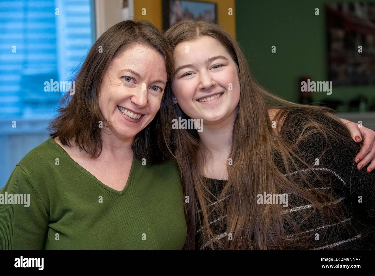 Portrait of a mother hugging her 17 year old daughter. (MR) Stock Photo