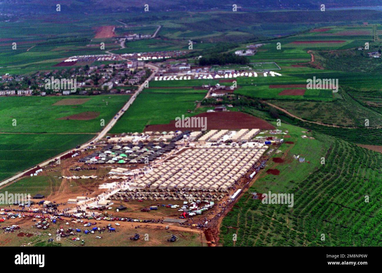 An aerial of a refugee camp near Kukes, Albania, from an MH-53E (not shown) from HM-15. HM-15 is currently embarked on the Amphibious Assault ship, USS INCHON (MCS-12) (not shown) which is operating in the Mediterranean and Adriatic Sea, supporting Operation Sustain Hope, a joint, combined NATO and U.S. military humanitarian relief effort in conjunction with civilian relief agencies. Operation Sustain Hope is bringing relief to thousands of refugees created from the recent unrest in the Kosovo region. Subject Operation/Series: SUSTAIN HOPE Base: Kukes Country: Albania (ALB) Stock Photo