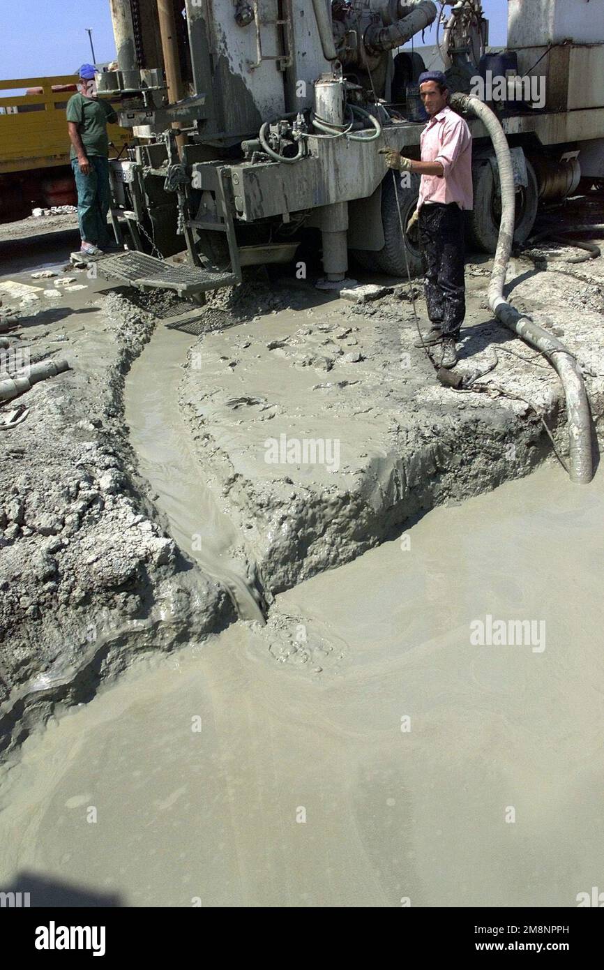 Water Laborer An Albanian laborer monitors the flow of mud from a potential water ...