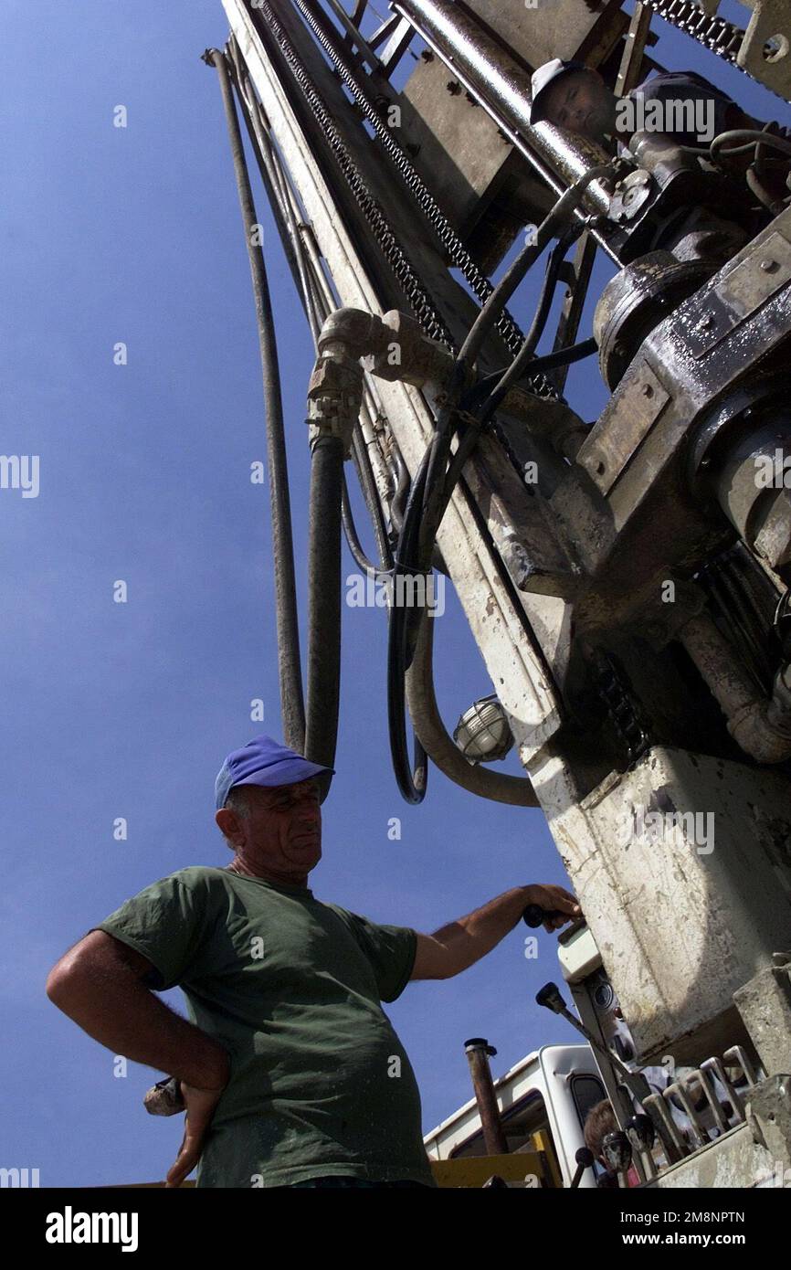 Water Laborer An Albanian laborer monitors the flow of mud from a potential water ...