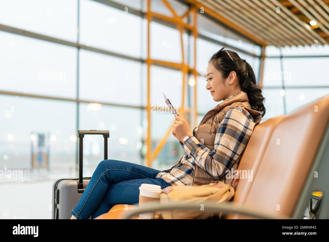 A young woman in the airport lounge Stock Photo - Alamy