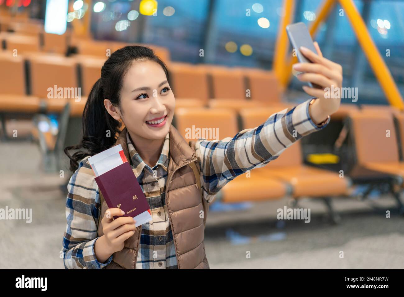 A young woman in the airport lounge Stock Photo