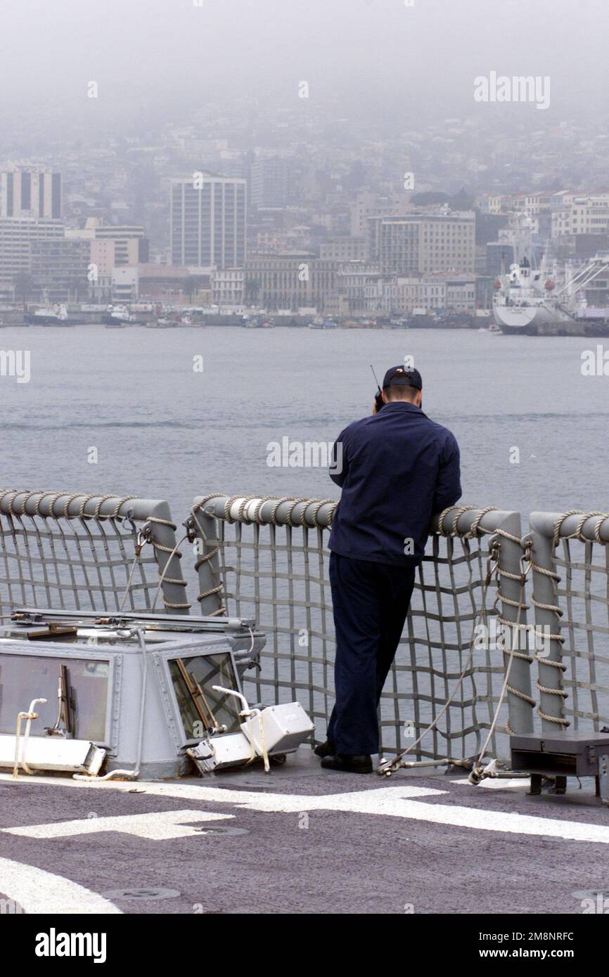 US Navy Radioman 2nd Class Adam Firth makes a cell phone call home to his wife while aboard USS REUBEN JAMES (FFG 57) in Valparaiso, Chile as Exercise TEAMWORK SOUTH '99 kicks off. Subject Operation/Series: TEAMWORK SOUTH '99 Base: USS Reuben James (FFG 57) Stock Photo