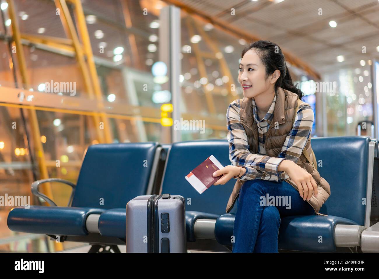 A young woman in the airport lounge Stock Photo - Alamy