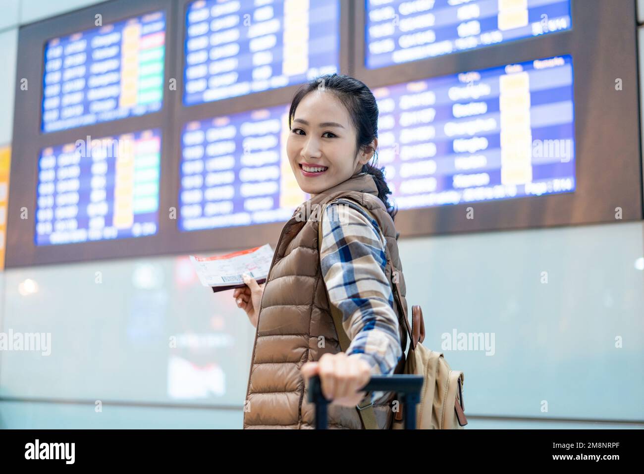 A young woman to check the flights Stock Photo - Alamy