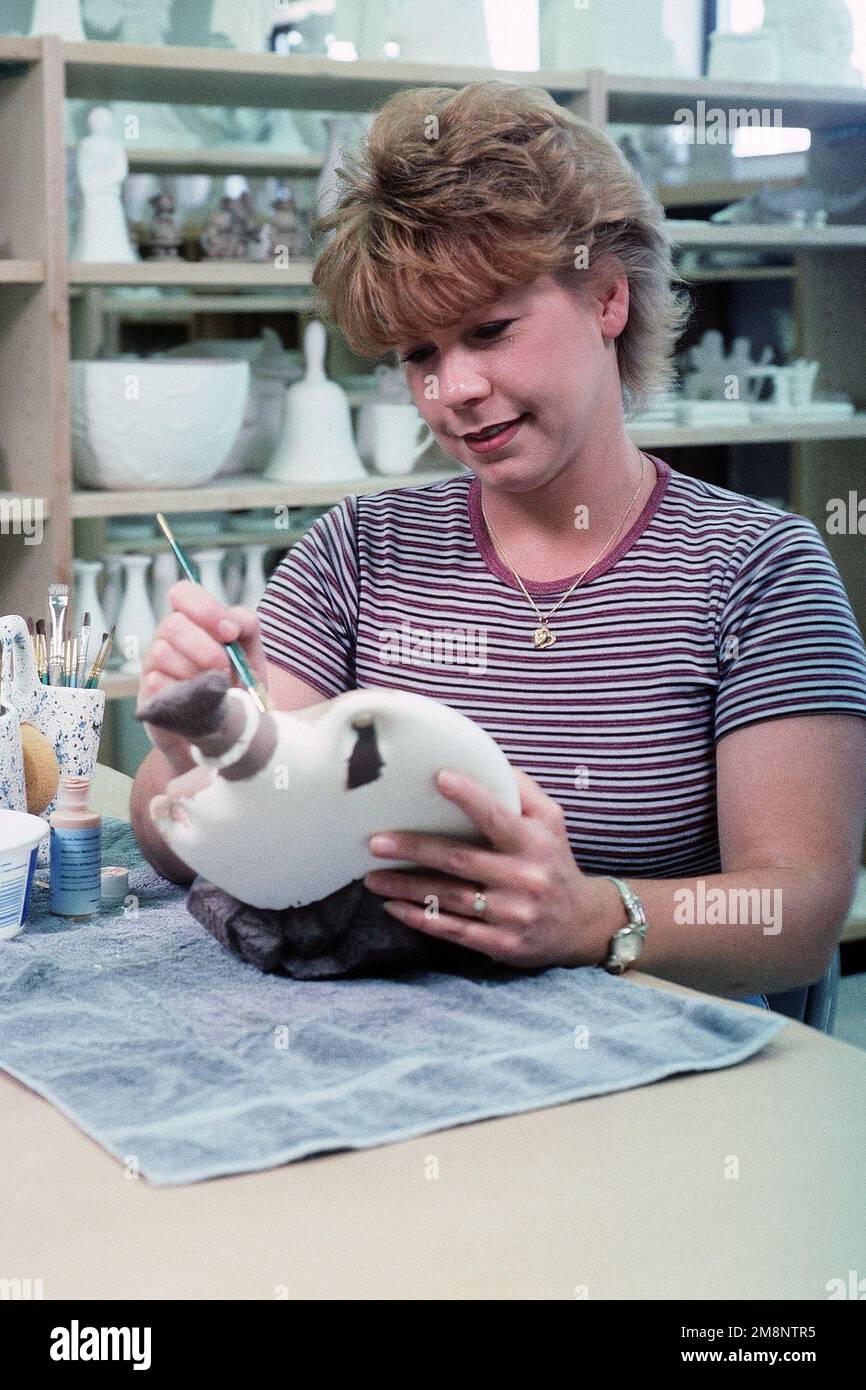 Lorna Lindberg paints her latest ceramics project at Holloman Air Force Base consolidated skills center. Bases offer families a variety of hands-on hobbies, including woodworking, ceramics and auto repair. Photograph used in the article 'Living in a Small Town,' from the August 1999 AIRMAN Magazine. Base: Holloman Air Force Base State: New Mexico (NM) Country: United States Of America (USA) Scene Major Command Shown: ACC Stock Photo