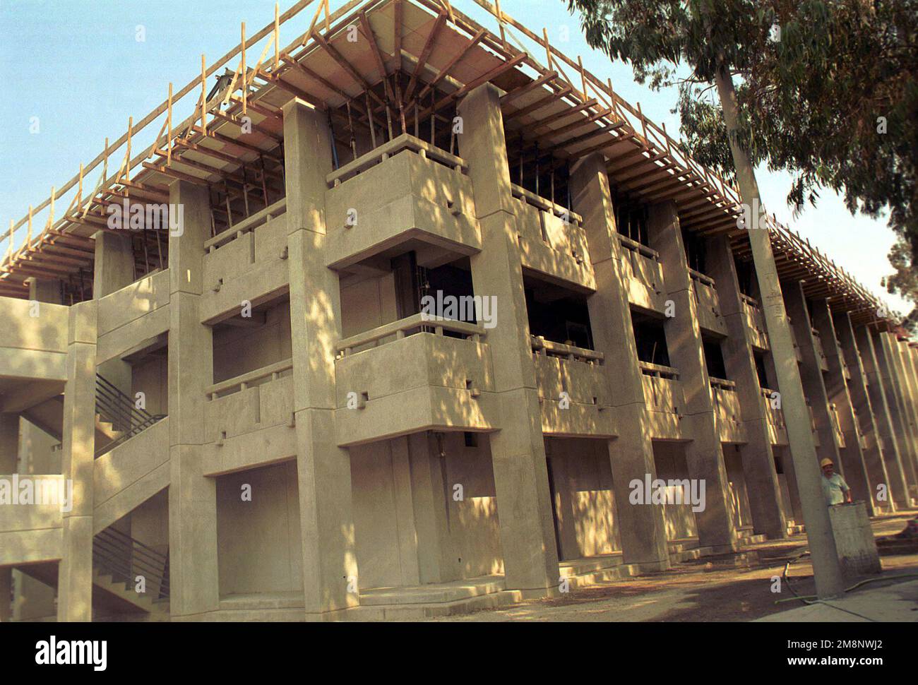 Left side front view medium shot as building 960 is the first 1+1 dormitory at Incirlik AB Turkey. The construction was started on 19 September 1999, and will be completed on 15 March 2000. Base: Incirlik Air Base, Adana Country: Turkey (TUR) Stock Photo