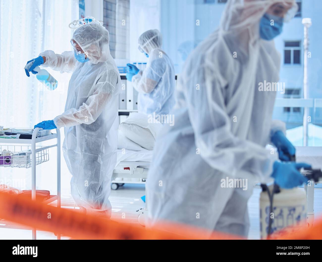 Biohazard team sterilise a hospital room together. Science team cleaning a medical center together. Medical team use antiseptic to clean a hospital Stock Photo