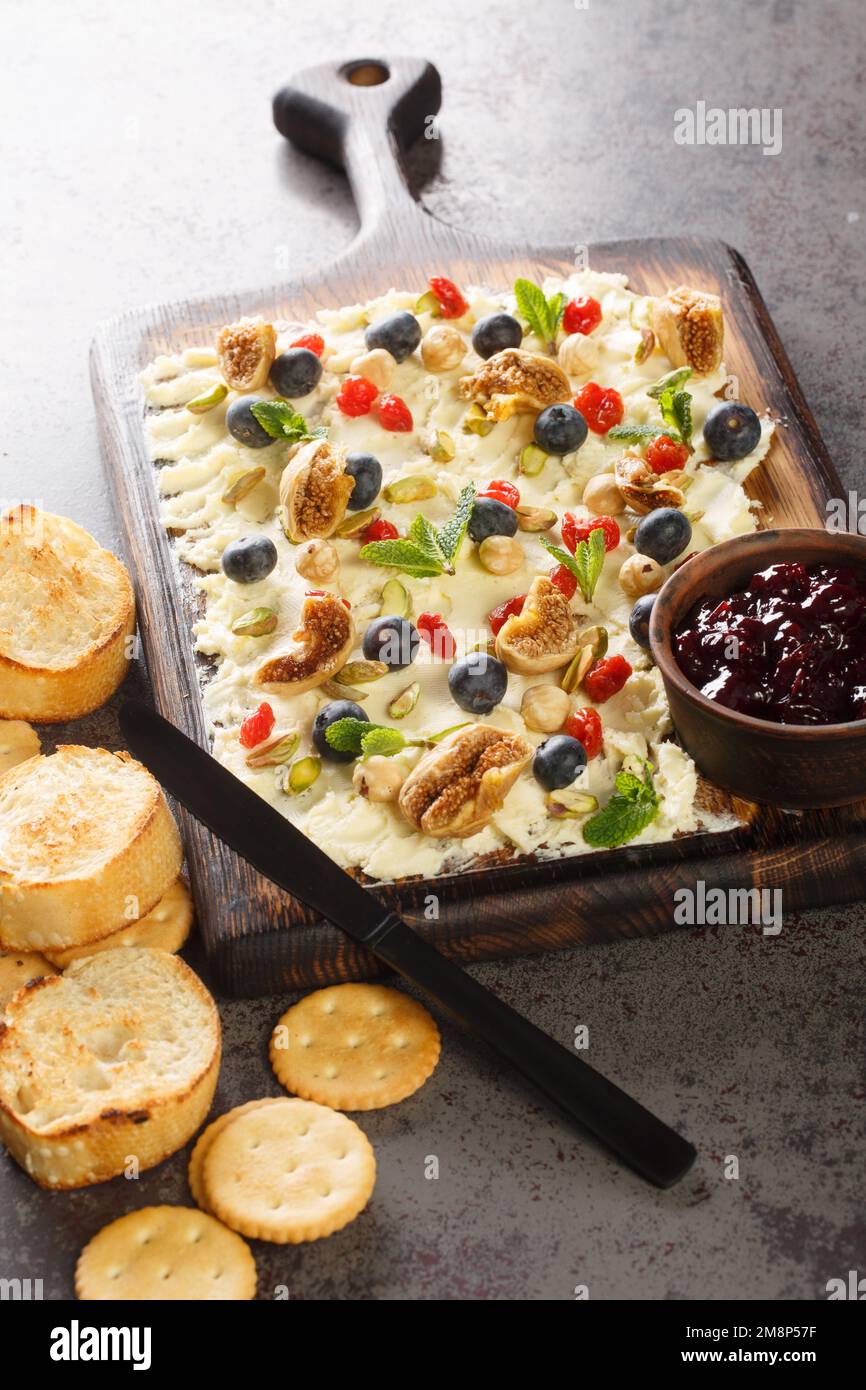 Trend food butter board with dried fruits, pistachios, hazelnuts and