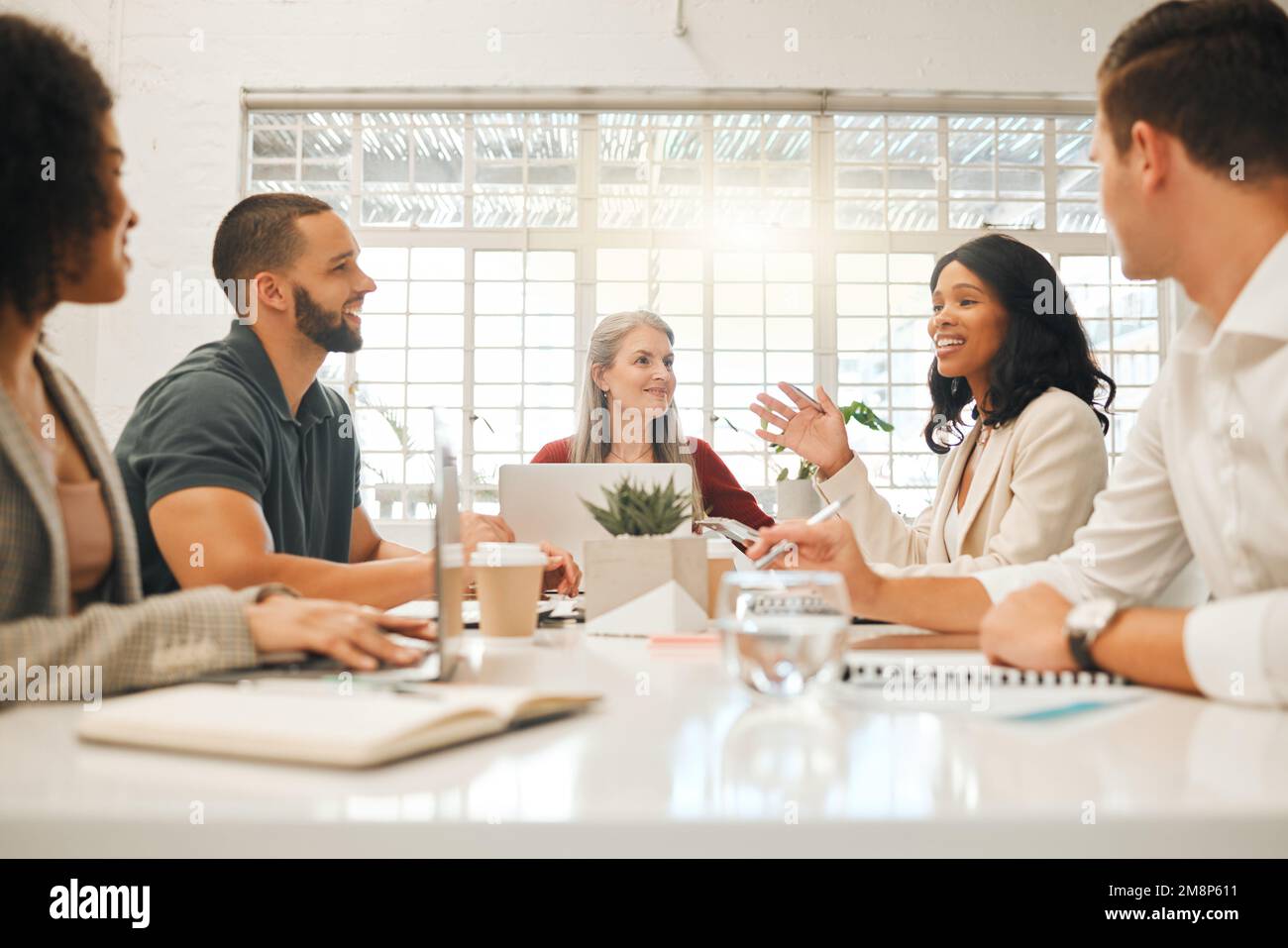 Diverse businesspeople brainstorm during a meeting. Architects planning their strategy. Businesspeople collaborate in an agency. African american Stock Photo