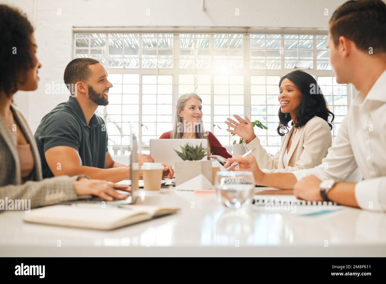 Diverse businesspeople brainstorm during a meeting. Architects planning ...