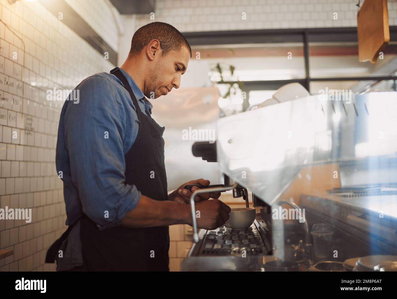 Focused barista making a cup of coffee. Barista making a cup of