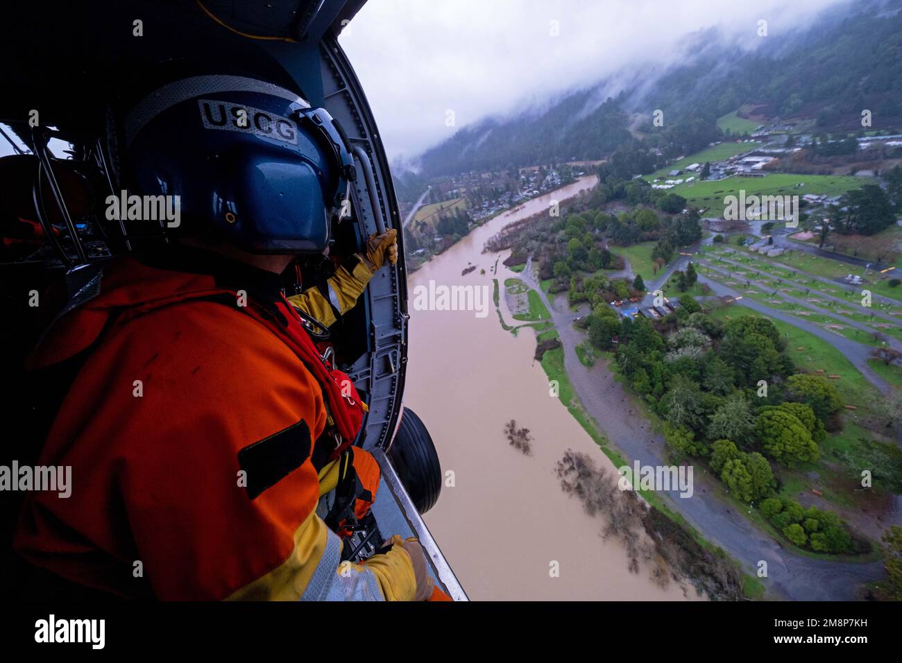California, USA. 11th Jan, 2023. Petty Officer 3rd Class Clayton Maidlow, an Aviation Survival Technician stationed at Coast Guard Air Station Astoria, surveys a flooded region of the Russian River during an overflight mission on January 11, 2023. U.S. Coast Guard aircrews deployed to the San francisco Bay Area from across the west coast in response to the recent flooding. Credit: U.S. Coast Guard/ZUMA Press Wire Service/ZUMAPRESS.com/Alamy Live News Stock Photo