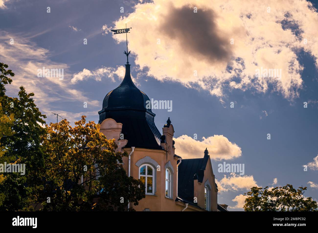 A low angle shot of an old-style building with an attic seen behind ...